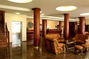 a lobby with chairs and a table and columns at Hotel Miramare in Njivice