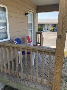 a porch with chairs on a house at Avon Motel in Avon