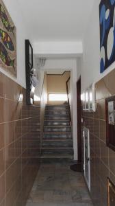 a hallway with a staircase in a building at Armação Beach Residences in Armação de Pêra