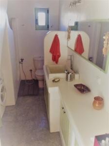 a bathroom with a sink and a toilet at Serifos Vacation Home in Rámos