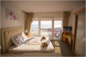 a bedroom with a bed with a teddy bear on it at Apartments Maja in Podstrana