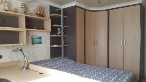 a bedroom with a bed and a desk with a lamp at Villa SportLife in Lloret de Mar