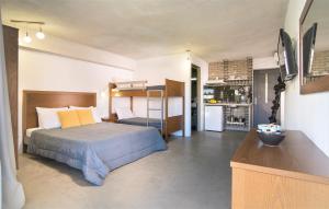 A bed or beds in a room at Erifili at Sarti Agora Apartments & Studios