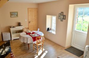 a dining room with a table and a window at Domaine de la Ronville in Wimereux