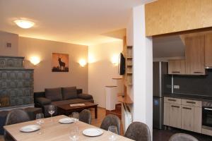 a kitchen and living room with a table and a couch at Chalet Gondelblick in Zell am See +37 photos