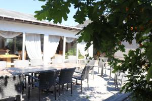 a dining table and chairs on a patio at Pension Hubertushof Monteurunterkunft in Freiberg