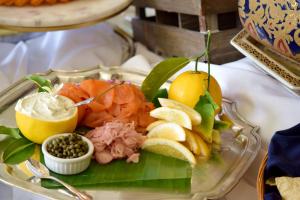 a plate of food with seafood and fruit on a table at Simpson House Inn in Santa Barbara