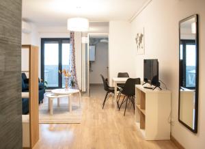 a living room with a table and a tv at Urban Nest Banu Manta in Bucharest