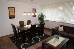 a living room with a table and chairs and a couch at Haus Karen in Schafflund