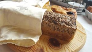 a loaf of bread sitting on a wooden plate at Hotel Boutique Il Castellino Relais in Vieste