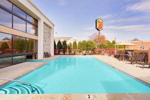 a swimming pool in front of a building at Super 8 by Wyndham Hermitage Nashville in Hermitage