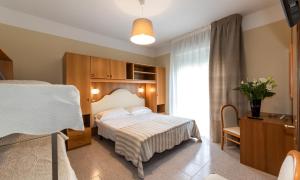 Postel nebo postele na pokoji v ubytování Acapulco Beach