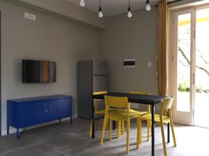 a dining room with a black table and yellow chairs at Casa Lazise in Lazise