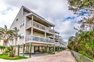 an apartment building with balconies on a street at Intercoastal Beach Suite in Clearwater