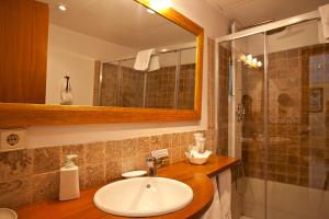 a bathroom with a sink and a shower at Agroturisme Na Martina in Portopetro