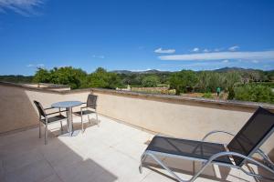 a patio with chairs and a table on a balcony at Agroturisme Na Martina in Portopetro