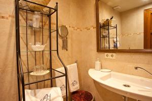 a bathroom with a sink and a toilet and a mirror at Agroturisme Na Martina in Portopetro