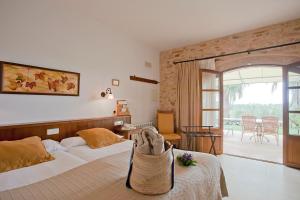 a bedroom with a bed with a bag on it at Agroturisme Na Martina in Portopetro
