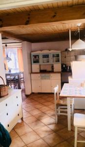 a kitchen with a table and a dining room at Samodzielny Dom Przy Lesie in Tereszewo