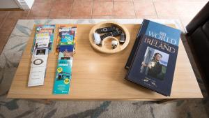 a table with two books and a remote control at Liberty Townhouses in Dublin