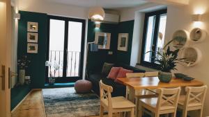 a living room with a table and a couch at Casa Al Porto Antico in Piran