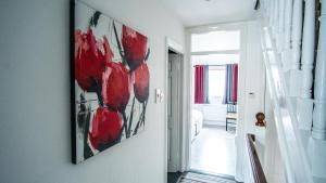 a hallway with a painting hanging on a wall at Liberty Townhouses in Dublin
