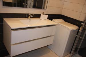 a bathroom with a sink and a toilet at Residence Albert Premier in Menton +21 photos
