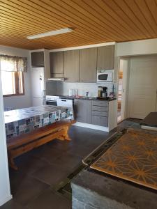 a kitchen with a bench in the middle of it at Järvitalo in Soini