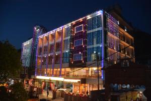 a building with christmas lights on the side of it at Hotel Kings Regency in Drang