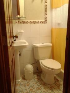 a bathroom with a toilet and a sink at Hotel Bethel in Cobán +19 photos