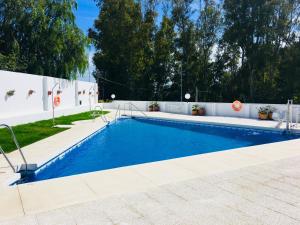a swimming pool in a backyard with a white fence at Toreblanca Lux in Fuengirola