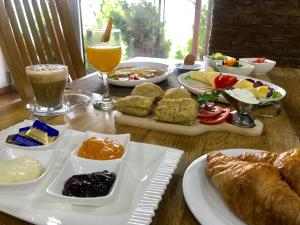 a table topped with plates of food and drinks at Motel As in Hadžići