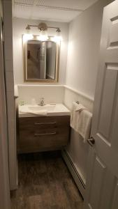 a bathroom with a sink and a mirror at Atlantic Motel in Point Pleasant Beach