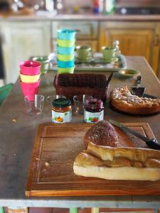 a table with a cutting board with bread and pastries at Conero Mare Verde in Numana