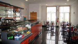 a restaurant with a counter and chairs in a room at Kolping House in Lamego