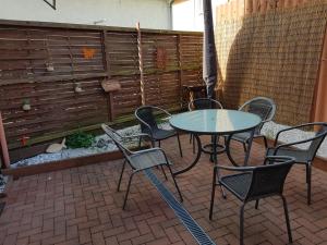 a table and chairs and an umbrella on a patio at "kleine Boddenburg" in Barth