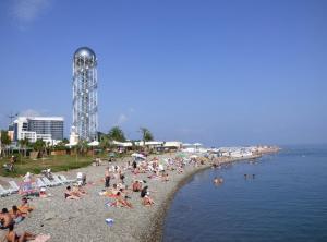 a crowd of people sitting on a beach at Apartment on Melashvili 24 (Old Batumi) in Batumi