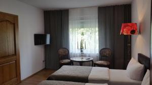 a hotel room with a bed and a table and a window at Monte Christo in Miastko