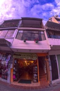 a store front of a building with a window at Samay Apart in Baños