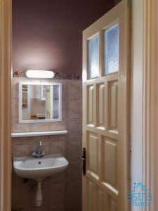 a bathroom with a sink and a mirror at Astra Studios in Astypalaia