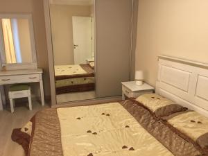 a bedroom with two beds and a large mirror at Royal Residence Nicosia in North Nicosia