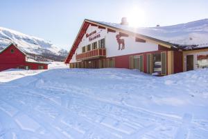 a building with a moose on the side in the snow at Maristova apartment 110 in Filefjell