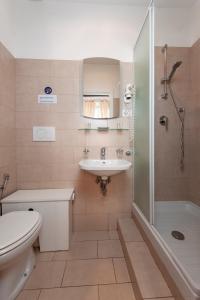 a bathroom with a toilet and a sink and a shower at Arie Romane Guesthouse in Rome