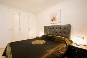 a bedroom with a large bed with a black headboard at Penthouse with amazing views in Vina del Mar in Playa Fañabe