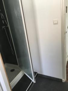 a shower with a glass door in a bathroom at Not far from Wissant in Marquise
