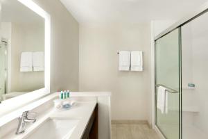 a white bathroom with a sink and a mirror at Holiday Inn Express & Suites Salisbury by IHG in Salisbury