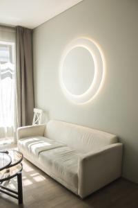 a living room with a white couch and a circular ceiling at Owl Apartments in Kaunas