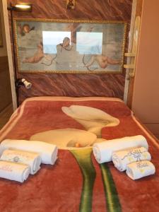 une chambre avec un lit, des serviettes et un tableau dans l'établissement Casa Vacanze In Love, à Marina di Montemarciano
