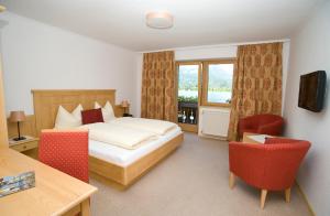 Postel nebo postele na pokoji v ubytování Hotel Garni Buchinger
