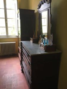 a large dresser in a room with a mirror at Casa Francesconi in Pietra Rossa